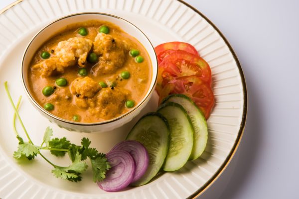 Indian spicy food Gobi Masala or cauliflower curry with green peas